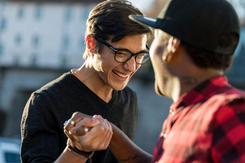 Two men shaking hands and smiling